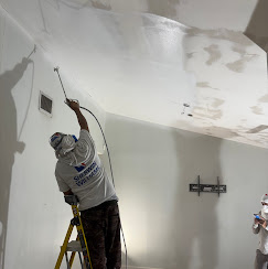 Contractor applying level 5 smooth finish on ladder — Jupiter FL